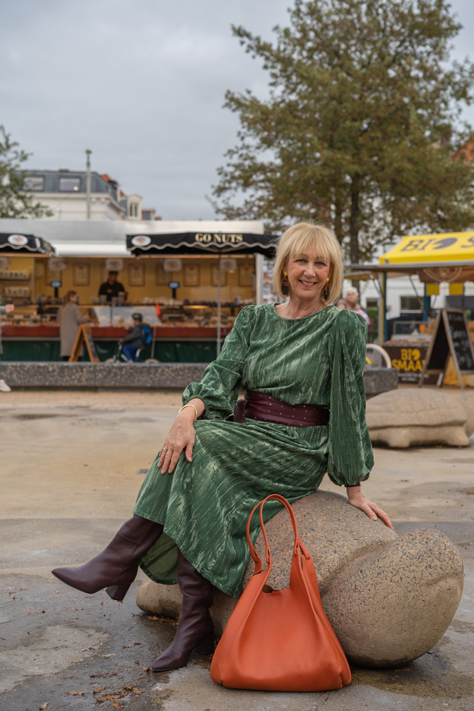 Green dress with burgundy belt and burgundy boots