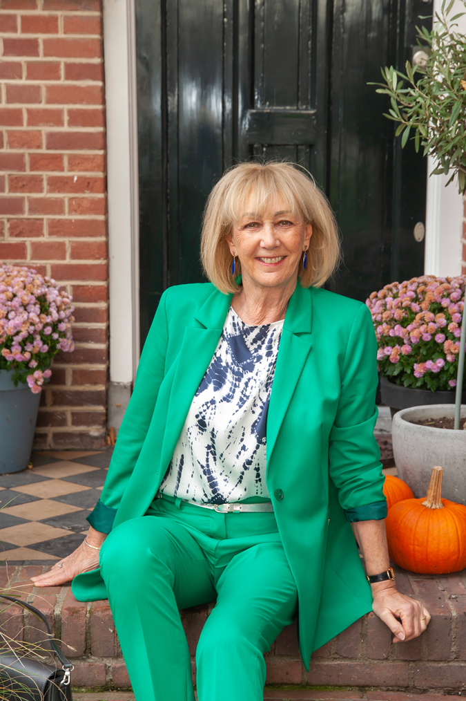 Green suit with blue, silver, white blouse and silver pumps