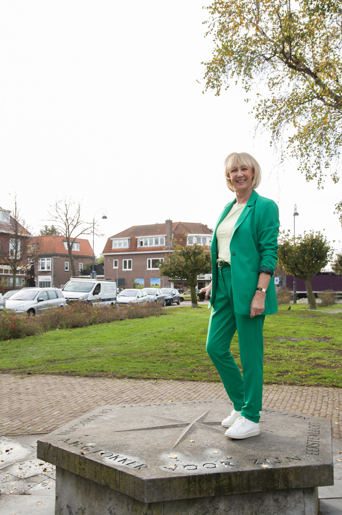 Green suit with soft yellow top and white trainers