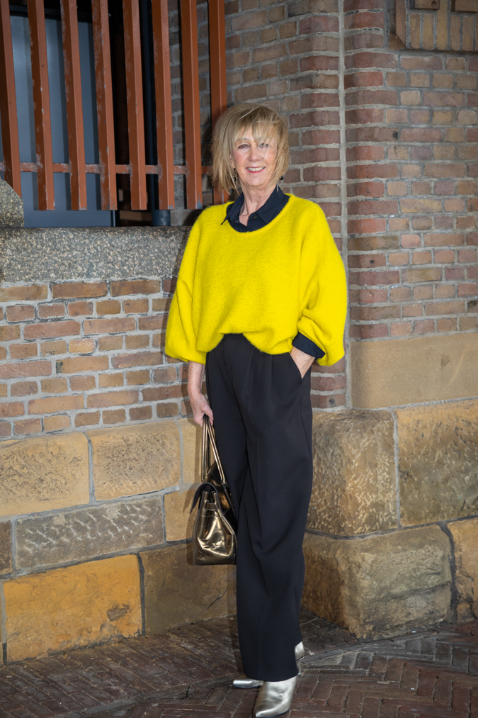 Wide black trousers and a big yellow jumper