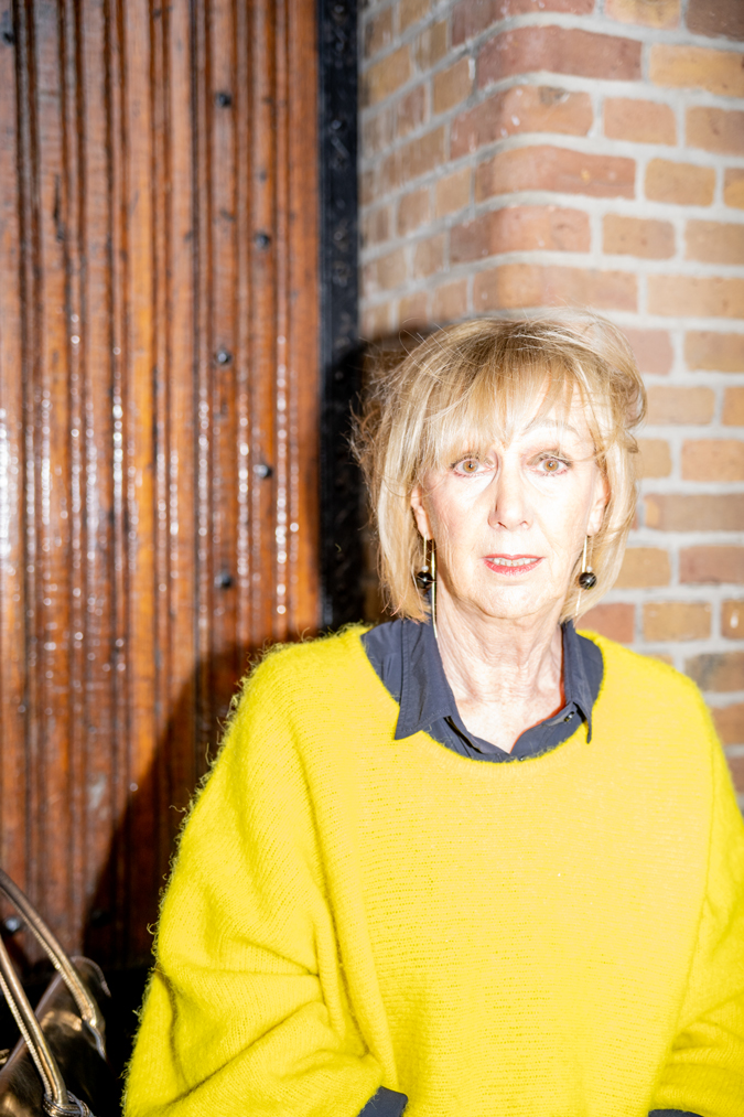 Wide black trousers and a big yellow jumper