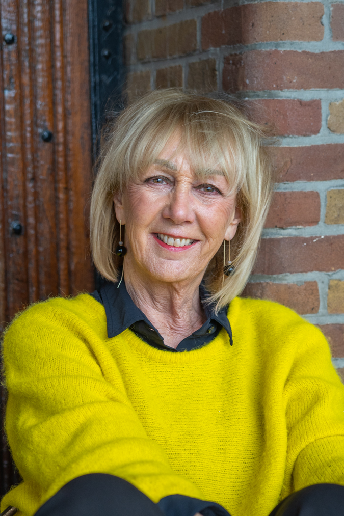 Wide black trousers and a big yellow jumper and black earrings by Lara Design