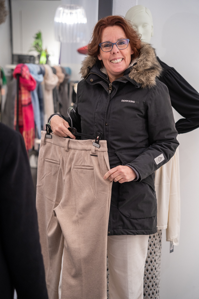 Claudia searching for a pair of trousers