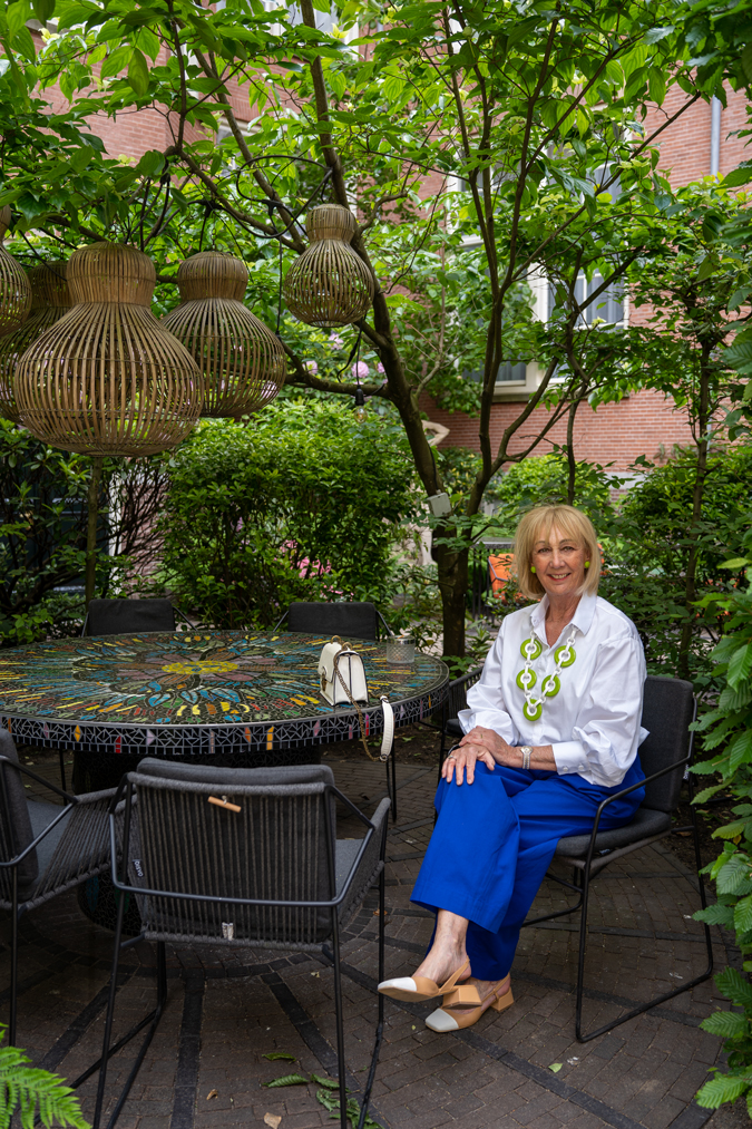Cobalt blue trousers with green and white necklace by Angela Caputi