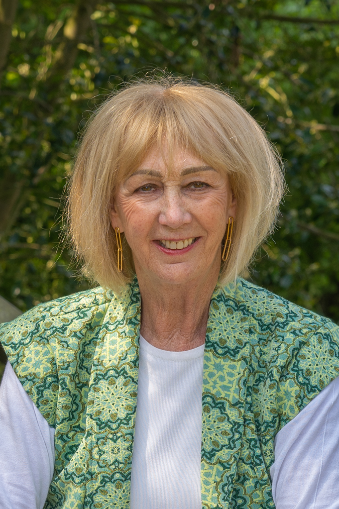Green patterned vest and paperclip earrings by Lara Design