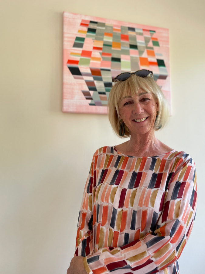 Multi coloured top with cognac coloured trousers.