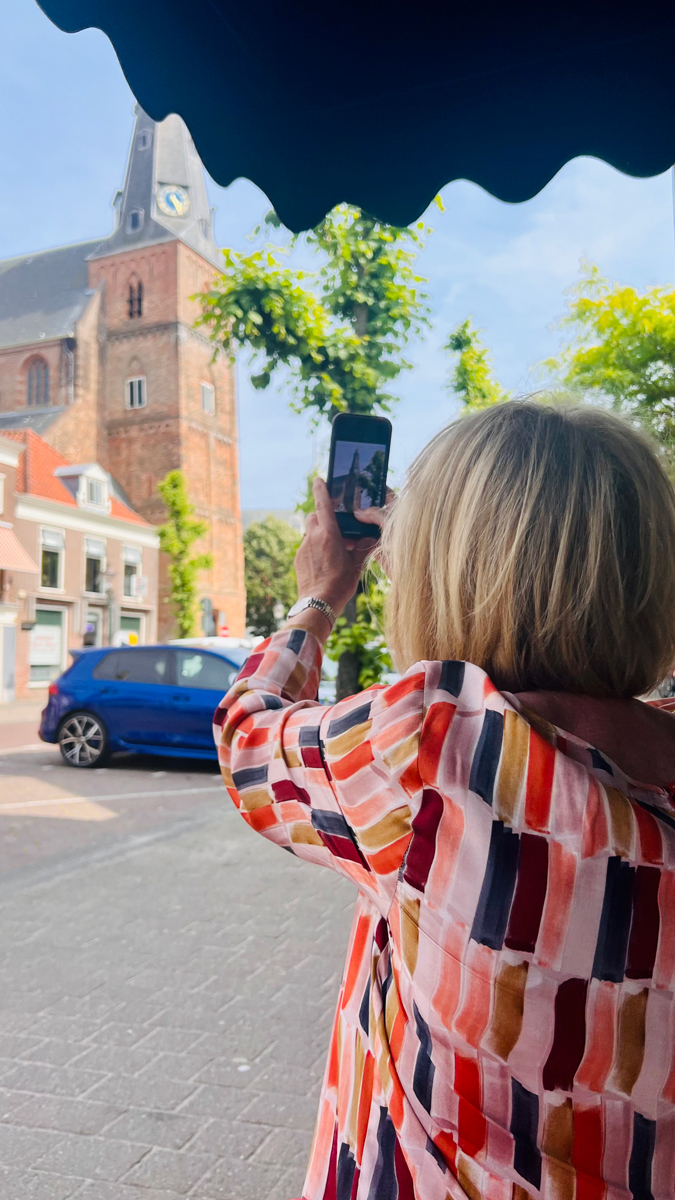 Multi coloured top with cognac coloured trousers.