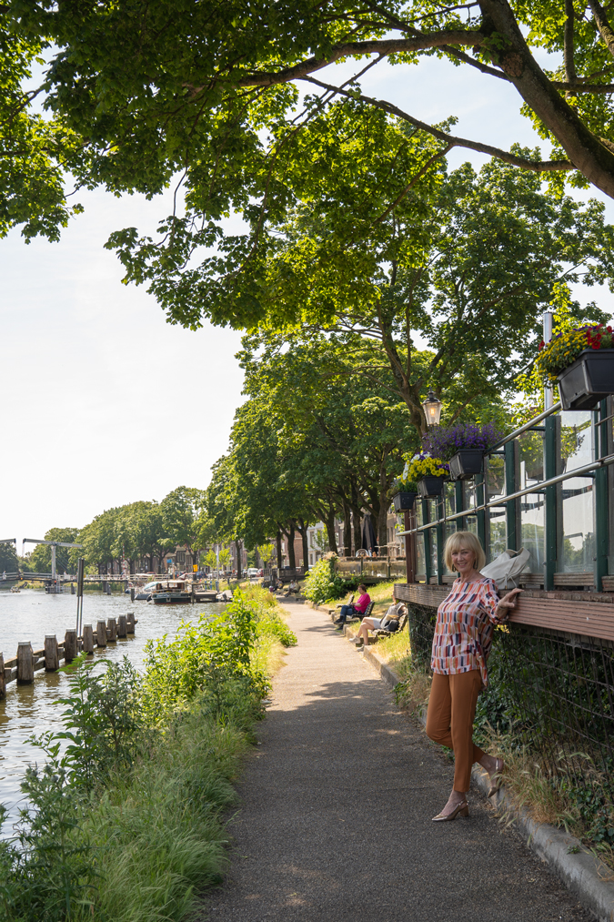 Multi coloured top with cognac coloured trousers.