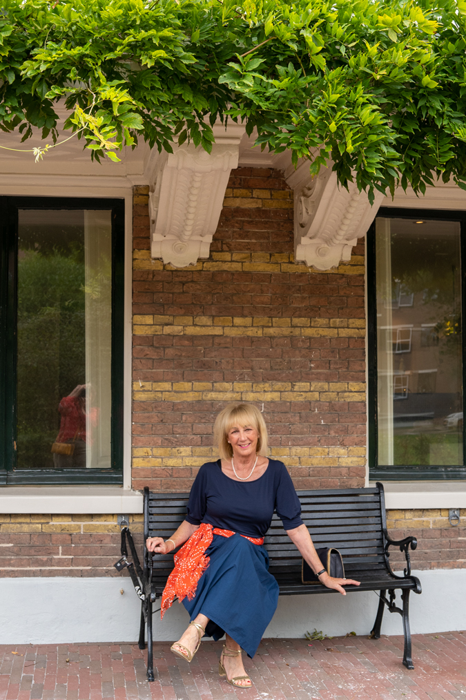 Blue monochrome outfit with an orange scarf
