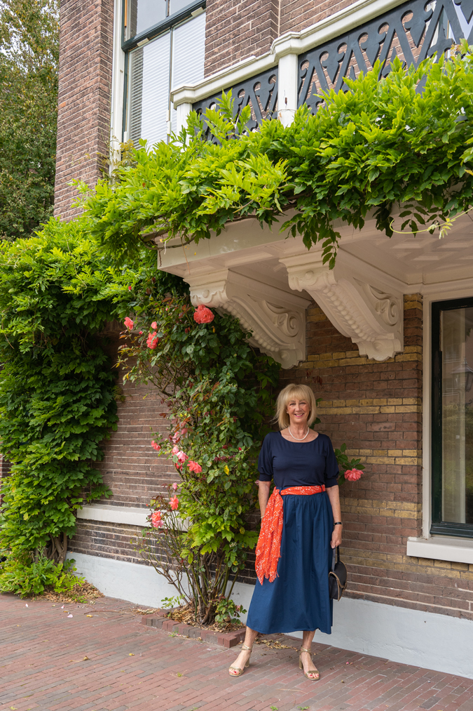 Blue monochrome outfit with an orange scarf