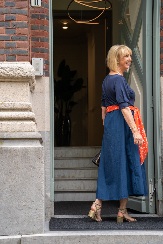 Blue monochrome outfit with an orange scarf