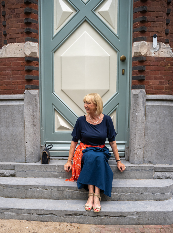 Blue monochrome outfit with an orange scarf