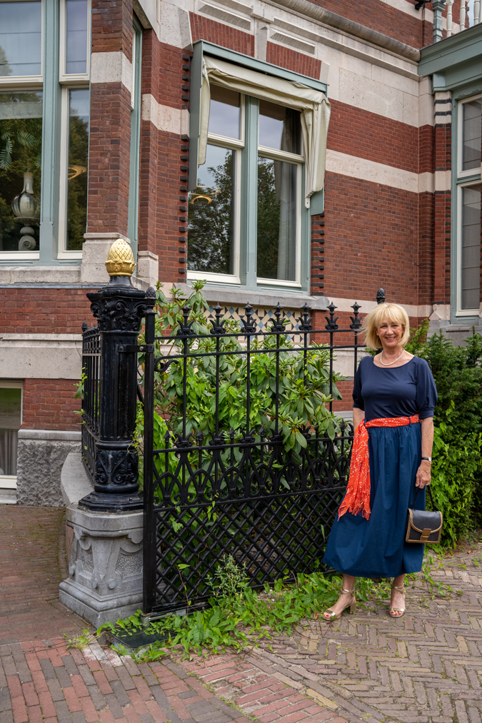 Blue monochrome outfit with an orange scarf