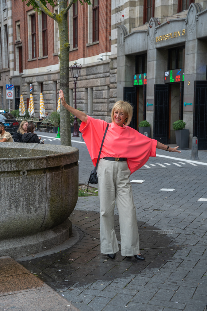 pebble coloured trousers with a neon pink top