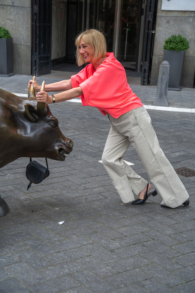 pebble coloured trousers with a neon pink top