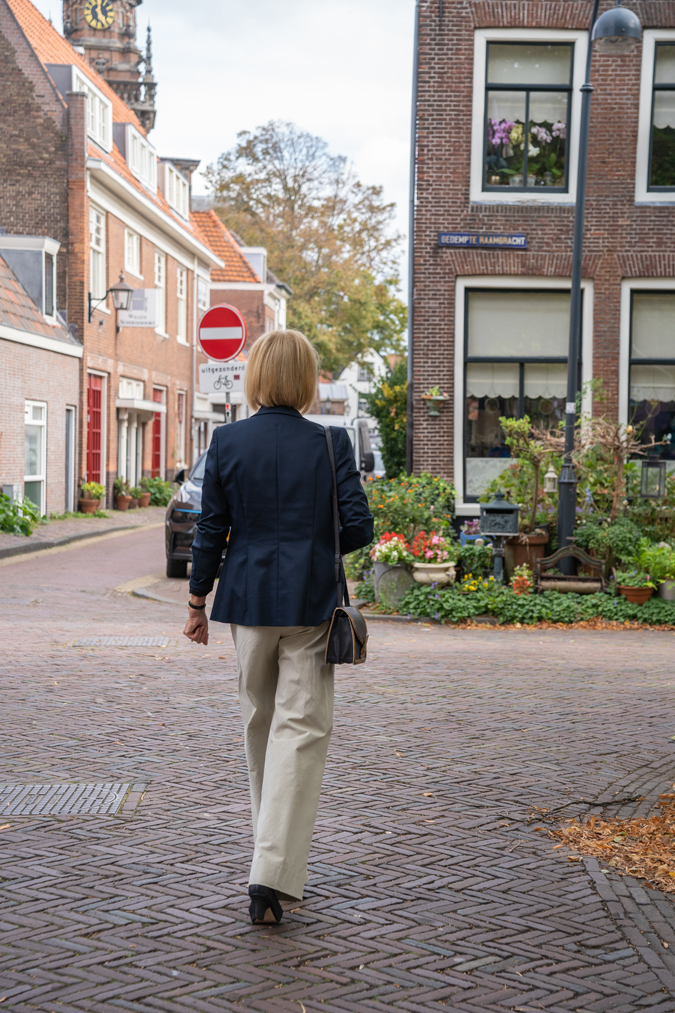 Pebble coloured trousers with a blue blazer and a blue blouse