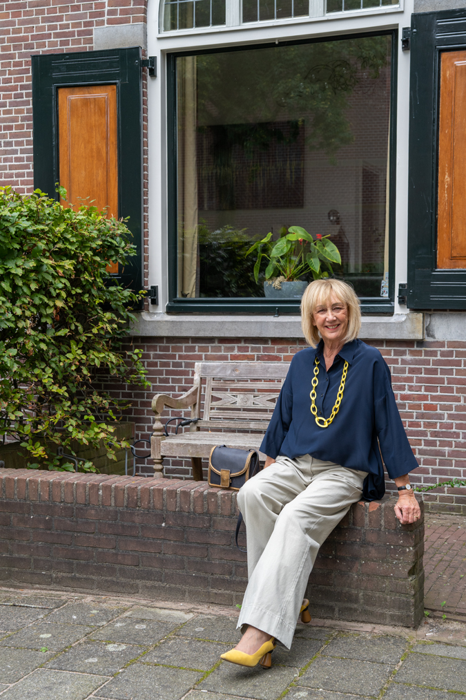 Pebble coloured trousers with a blue blazer and a blue blouse