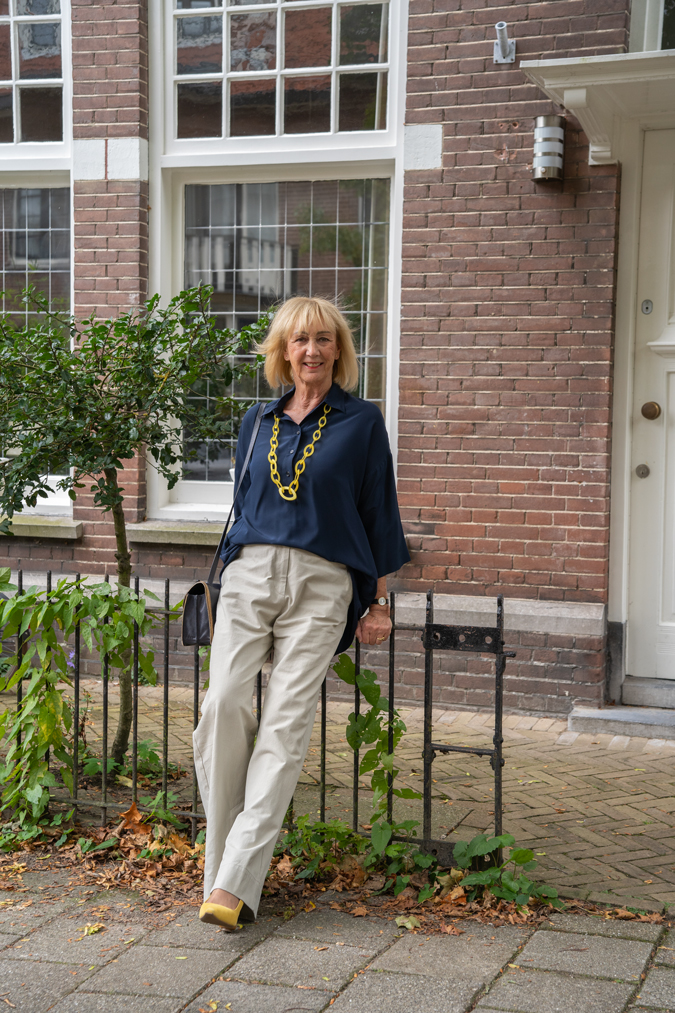 Pebble coloured trousers with a blue blazer and a blue blouse