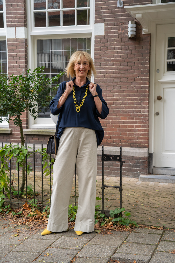 Pebble coloured trousers with a blue blazer and a blue blouse