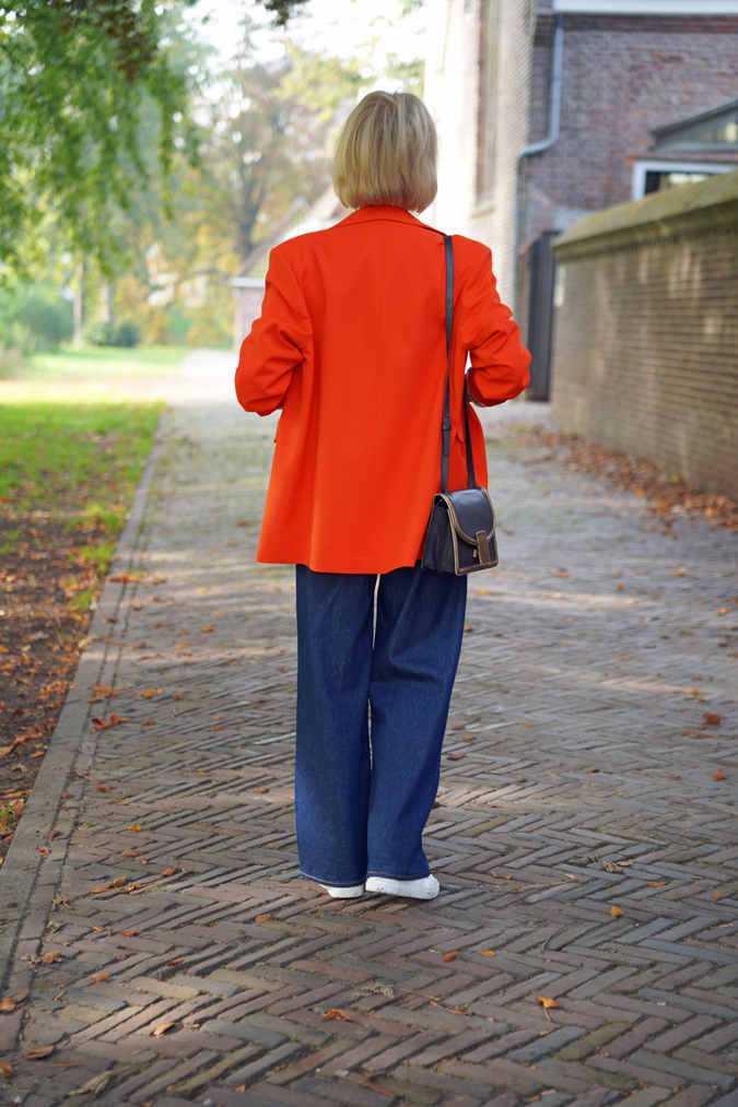 Wide leg jeans with an oversized orange blazer