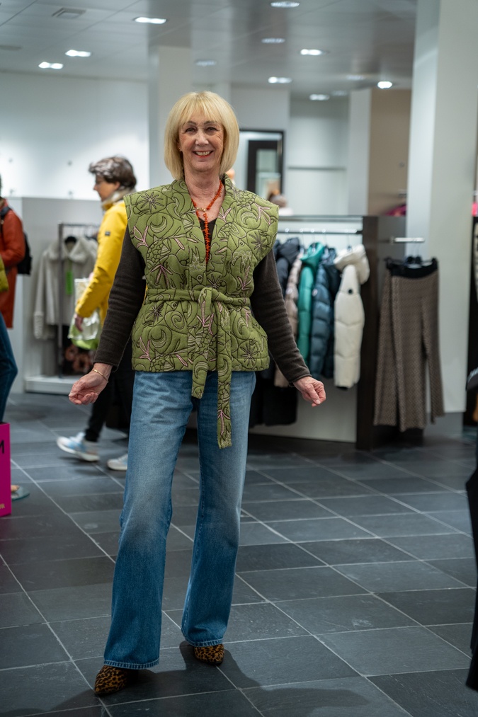Wide leg jeans with a brown jumper and green vest