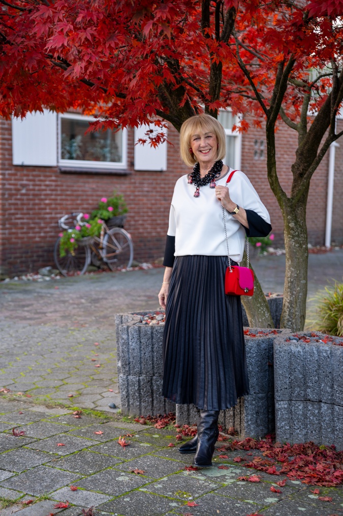 Pleated skirt and the Angela Caputi padlock necklace