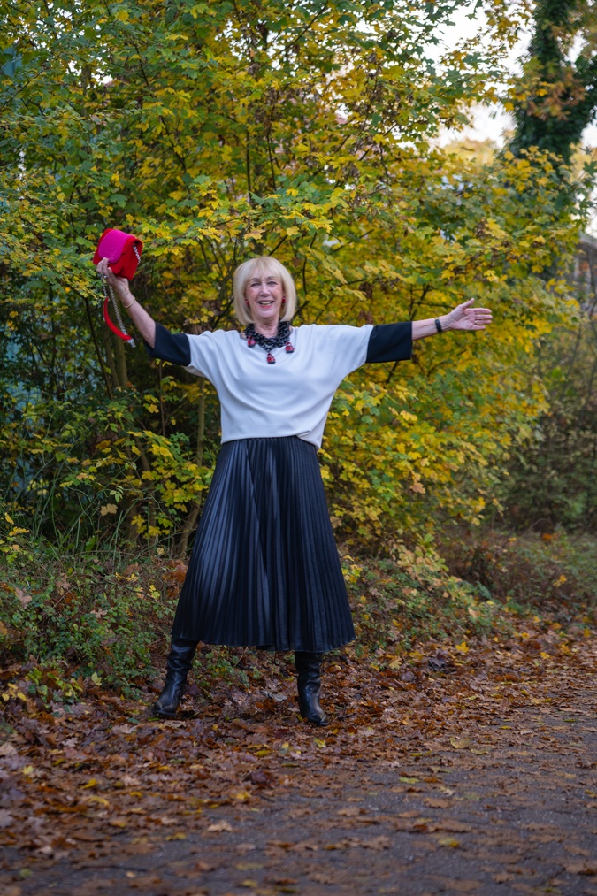 Pleated skirt and the Angela Caputi padlock necklace