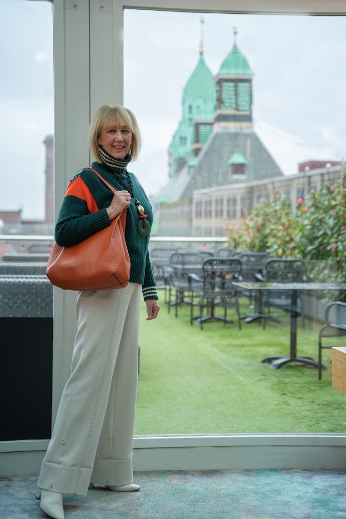 Green jumper with cream trousers