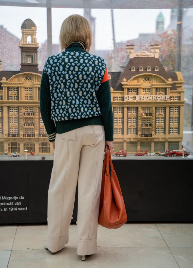 Green jumper with cream trousers