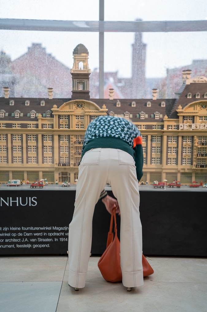 Green jumper with cream trousers