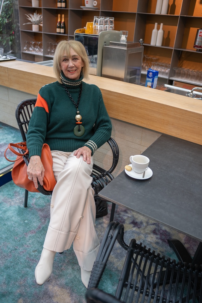 Green jumper with cream trousers