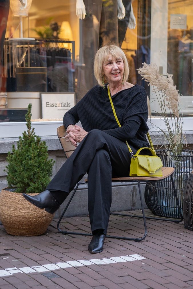 All black outfit with chartreuse crossbody bag