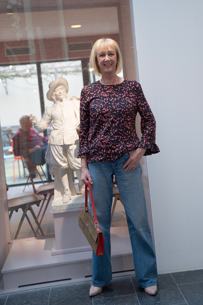 pink and black blouse with wide leg jeans