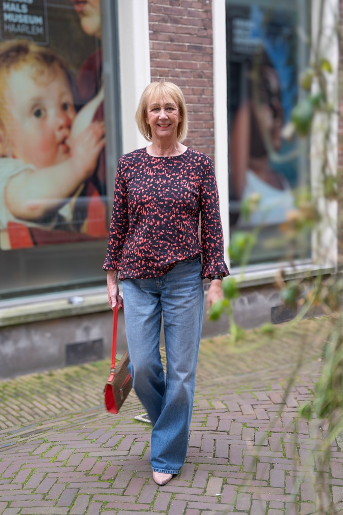 pink and black blouse with wide leg jeans