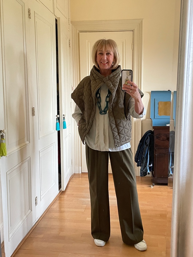 Olive coloured trousers with a pale blue blouse