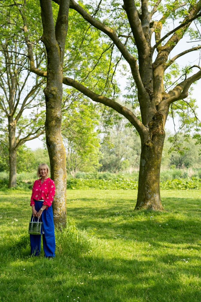 Bright blue trousers with a bright pink blouse