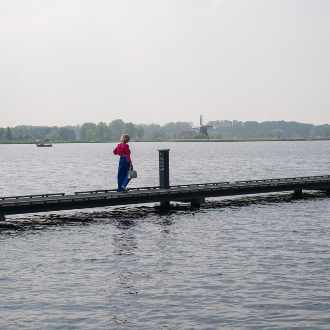 Bright blue trousers with a bright pink blouse