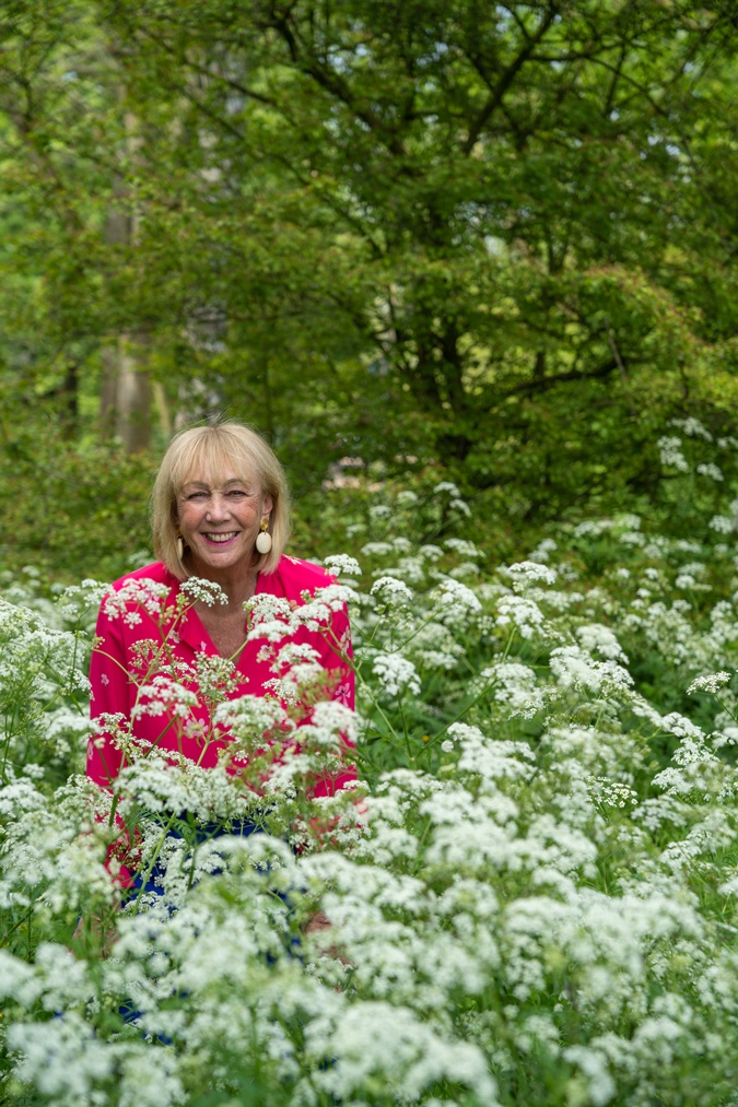 Bright blue trousers with a bright pink blouse
