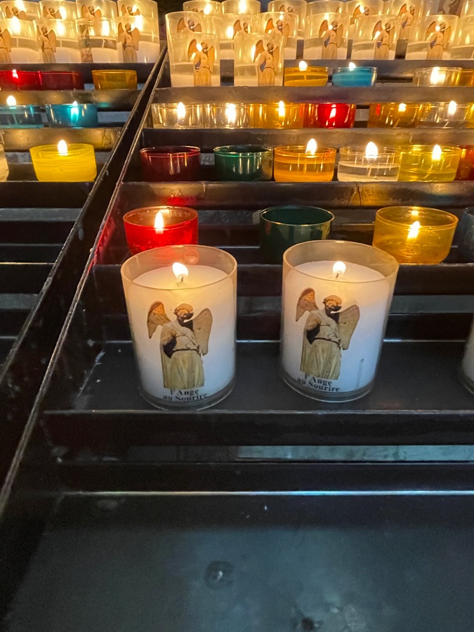 Lighting candles at the cathedral in Reims