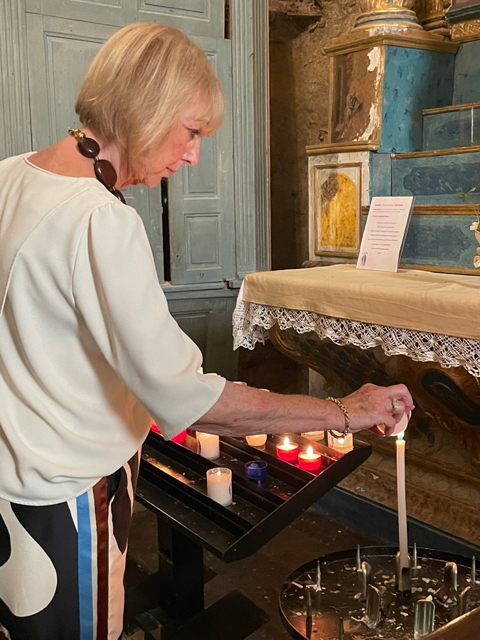 Lighting candles at the church in Ansouis