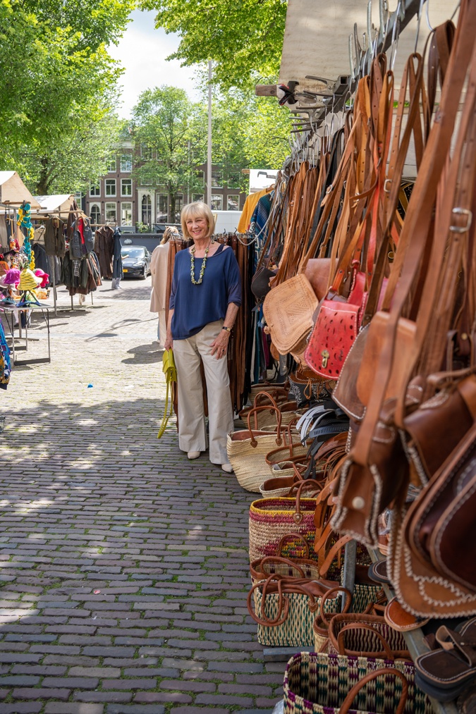Pebble coloured trousers with a colourful necklace