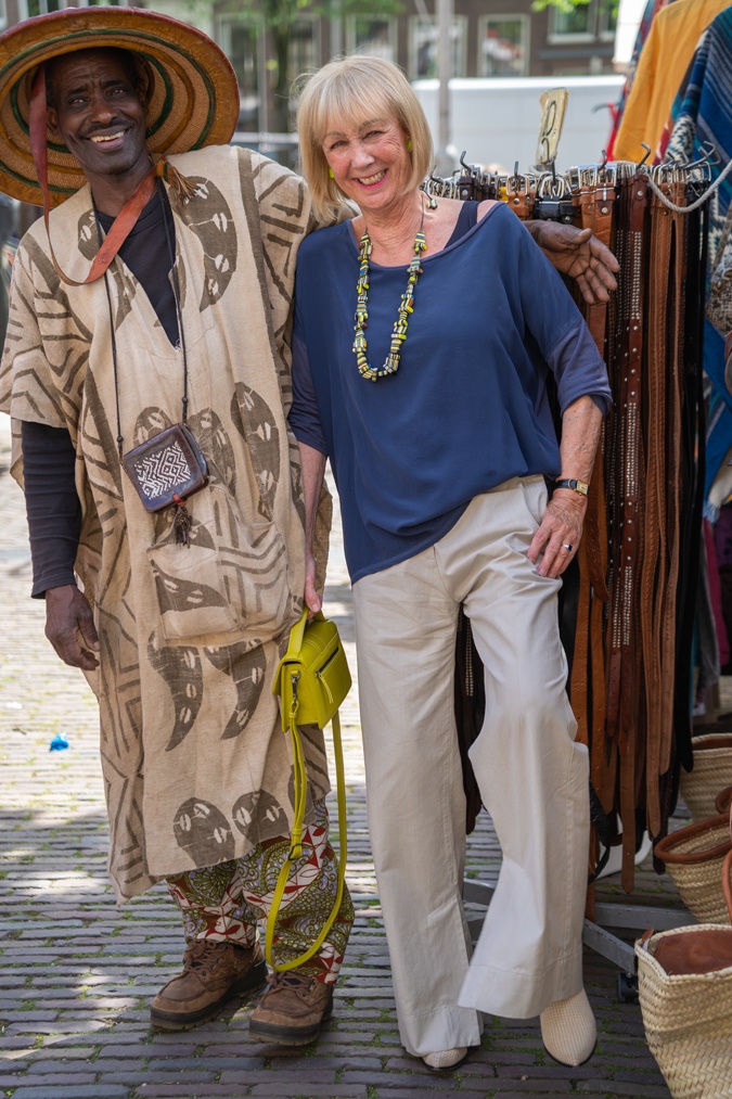Pebble coloured trousers with a colourful necklace