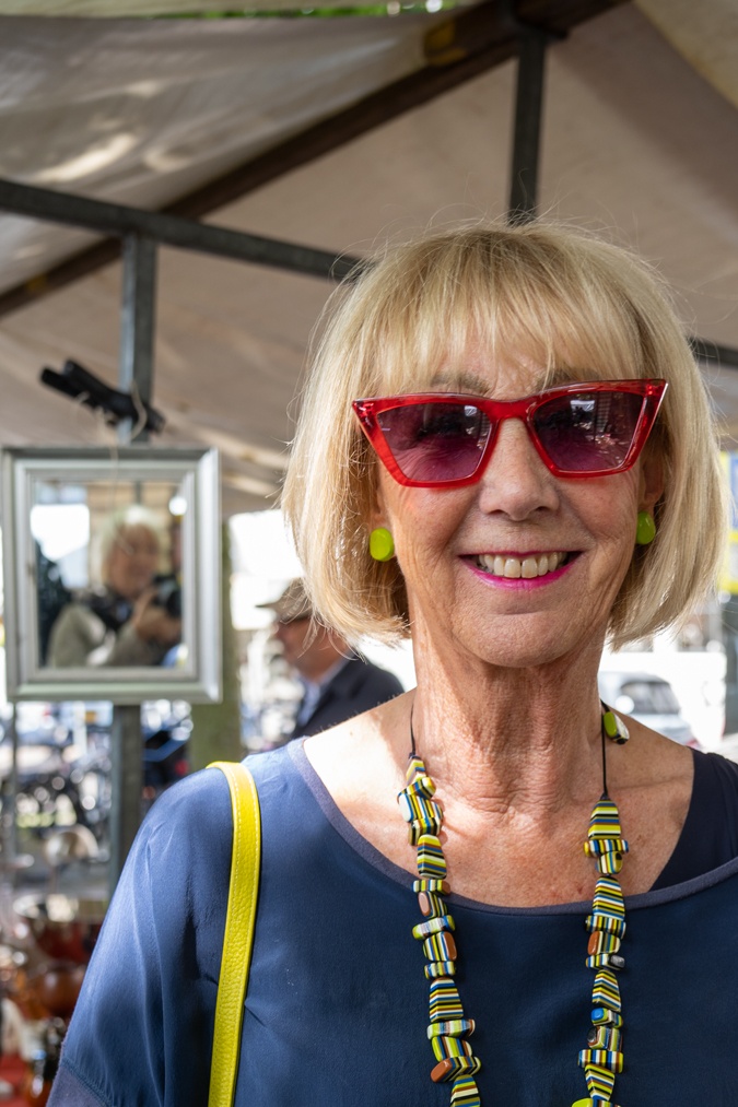 Pebble coloured trousers with a colourful necklace