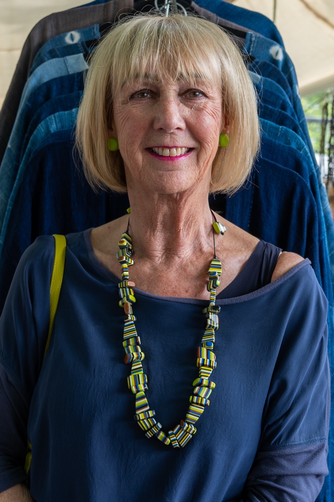 Pebble coloured trousers with a colourful necklace