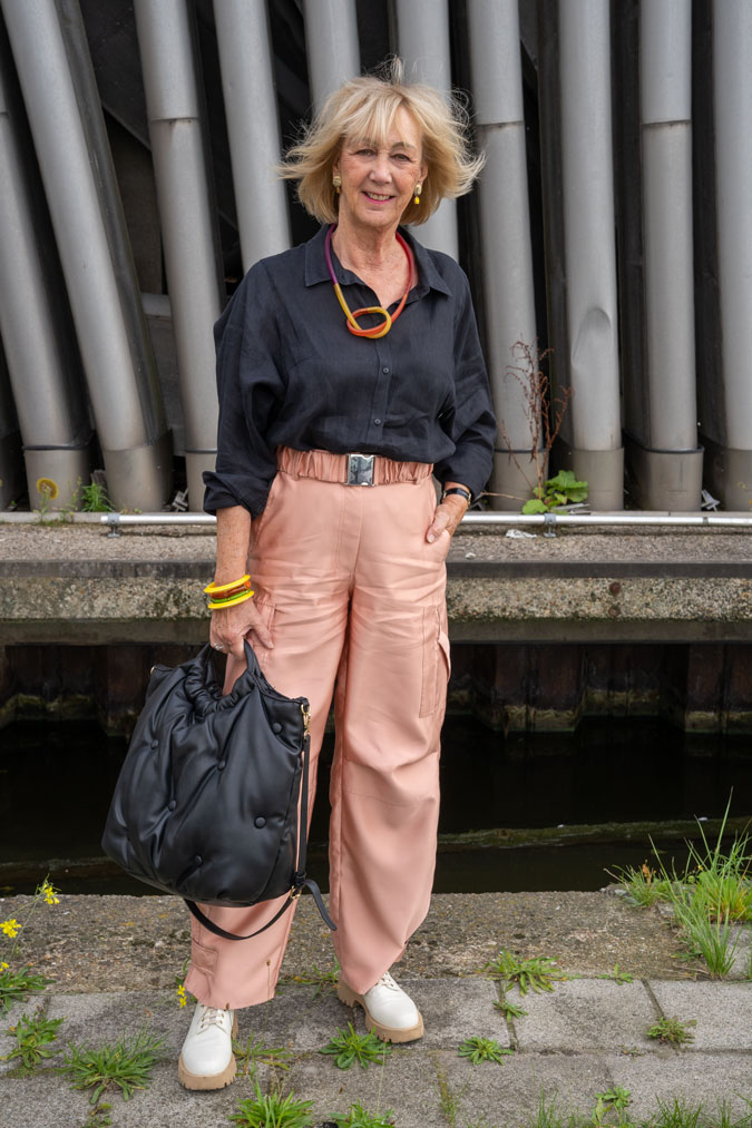 pink cargo trousers with a black linen shirt