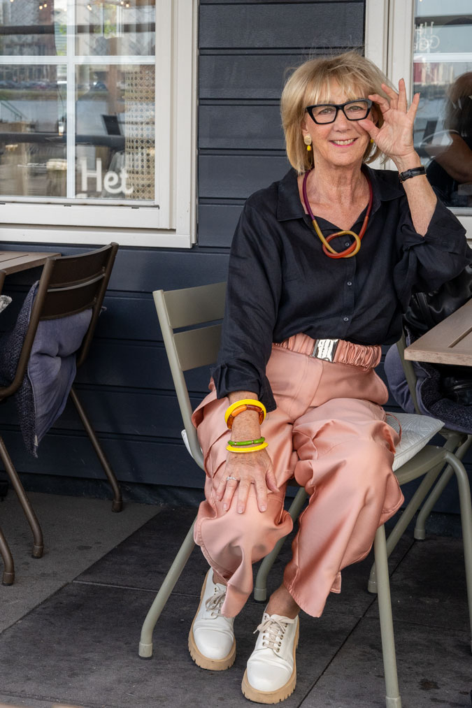 pink cargo trousers with a black linen shirt