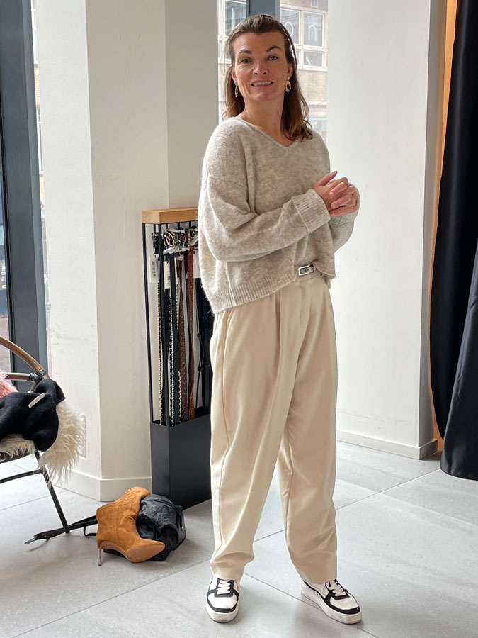 Anke trying on a cream jumper