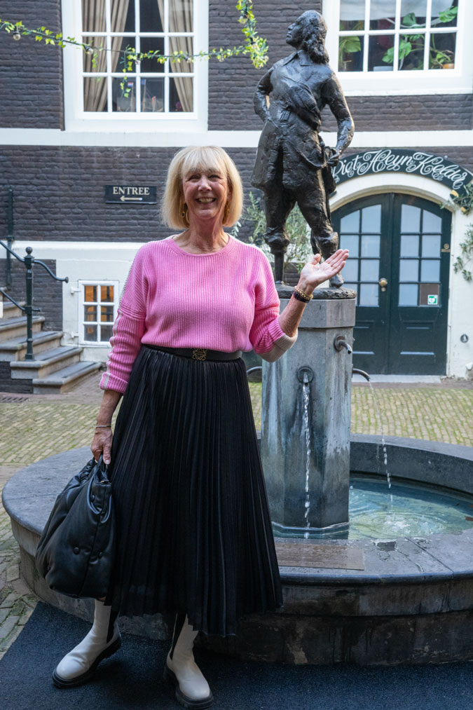 Black pleated skirt with a pink jumper