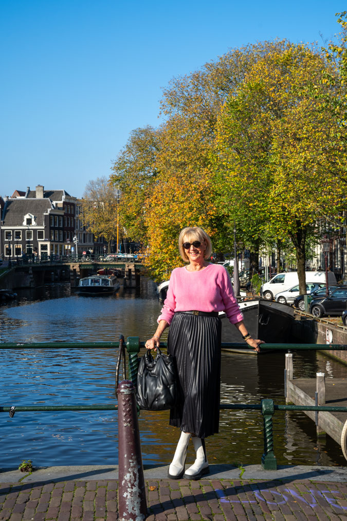Black pleated skirt with a pink jumper