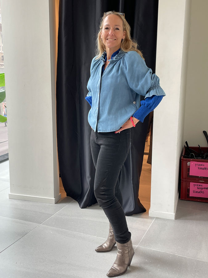 Sabine trying on a denim shirt